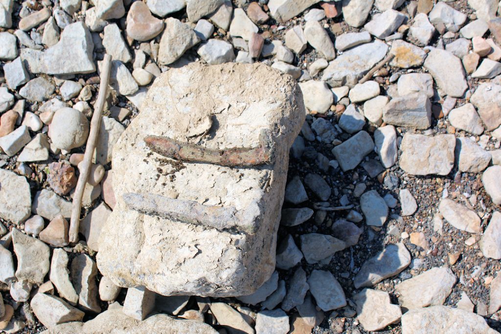 Railroad spikes can be found along the breaker wall. Leave them so others can experience the find!